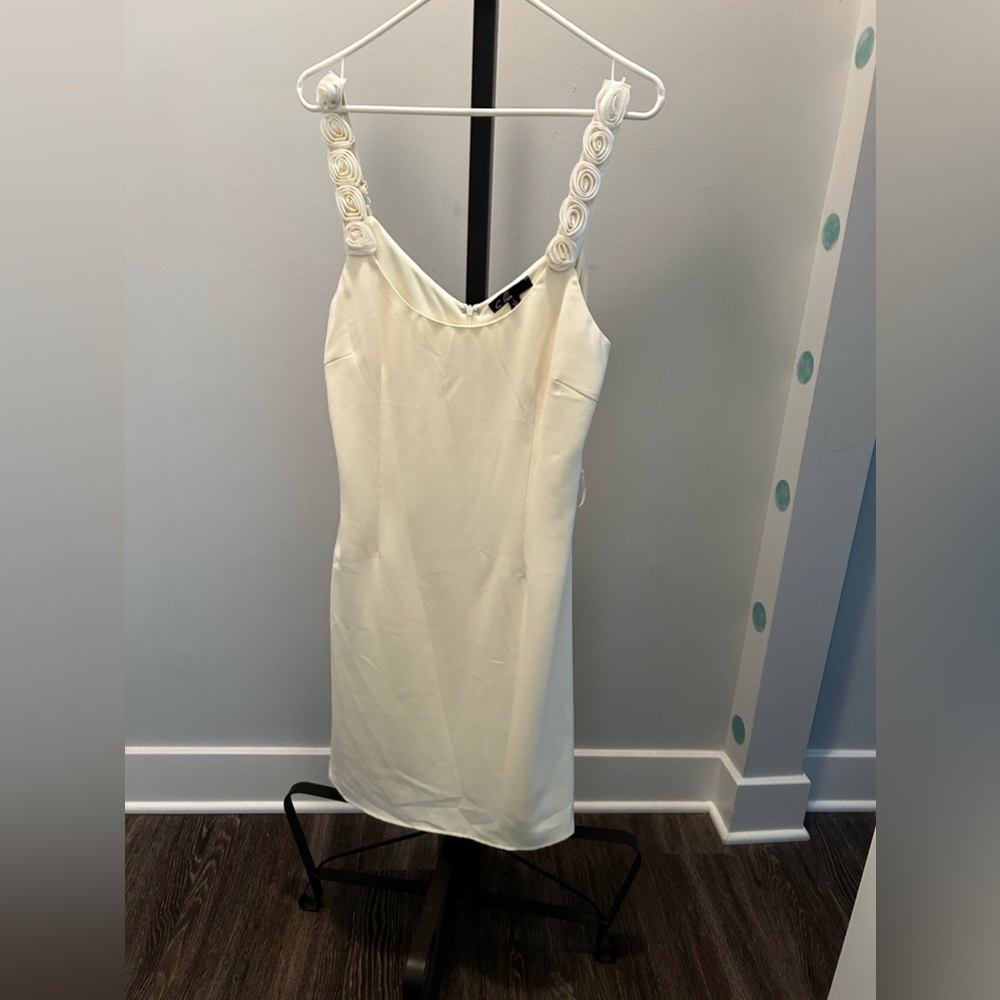 Light cream colored dress with detailed roses on straps.